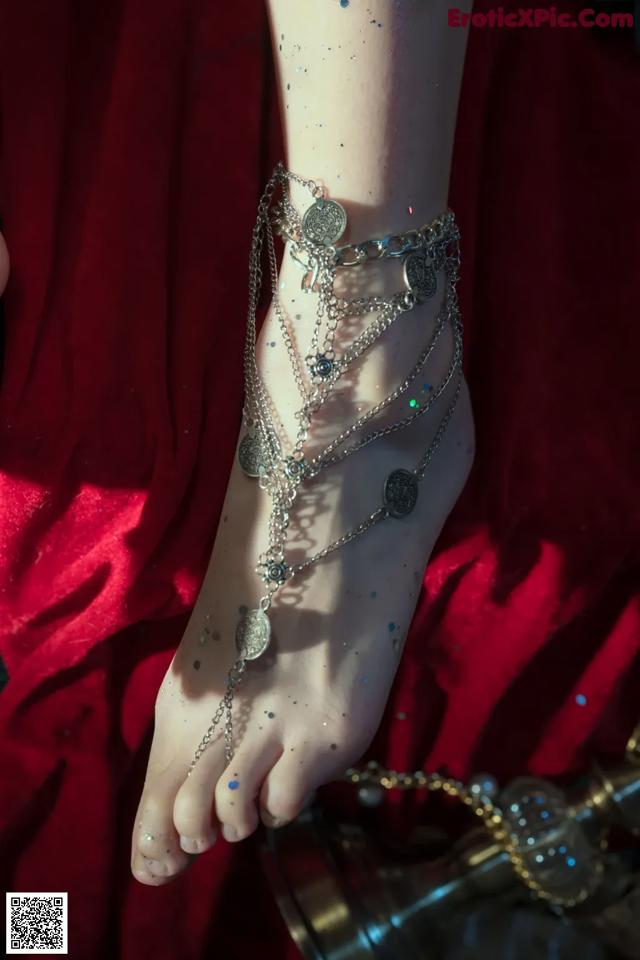 A close up of a person wearing a pair of barefoot sandals.